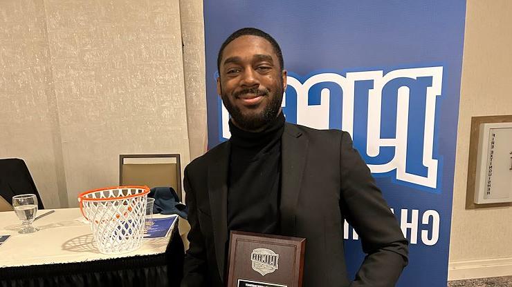 Mustangs Men's Basketball Head Coach Koran Prince holds the NJCAA North Atlantic Coach of the Year plaque